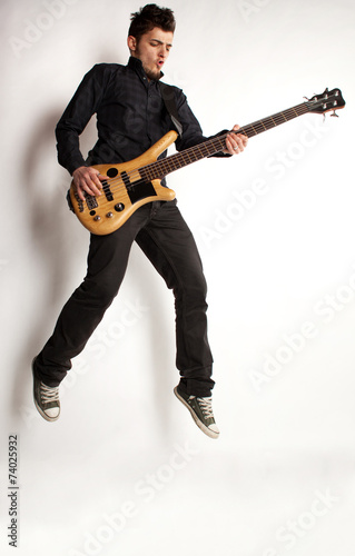 Jumping bass player on a white background
