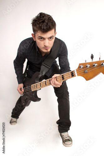 Focused bass player in black