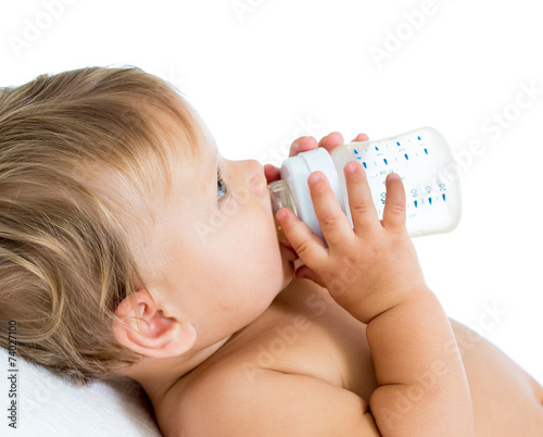 baby holding bottle and dri...