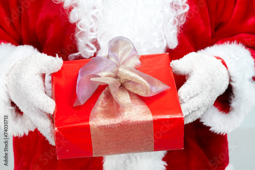 Hands of Santa Claus with gift © Petrik