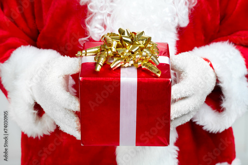 Hands of Santa Claus with gift