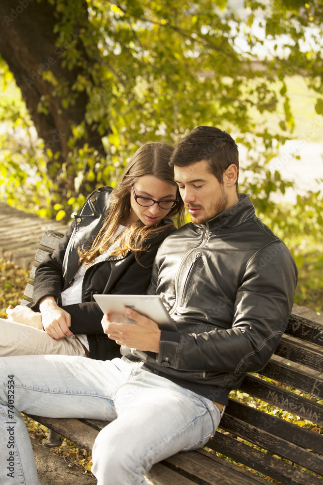 Happy Couple Using Tablet Computer Outdoor Happy Couple Using Tablet Computer Outdoor