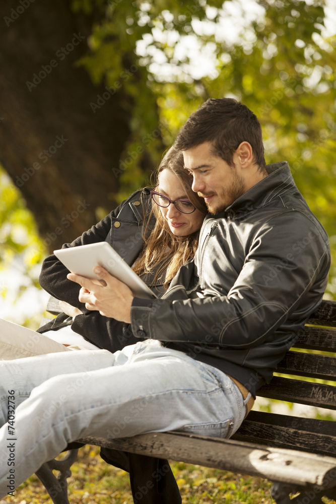 Happy Couple Using Tablet Computer Outdoor Happy Couple Using Tablet Computer Outdoor