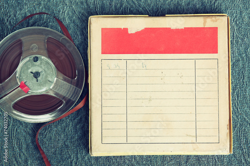 top view of old sound recording tape, reel to reel type and box photo