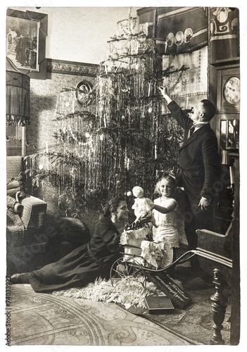 parents and child with christmas tree