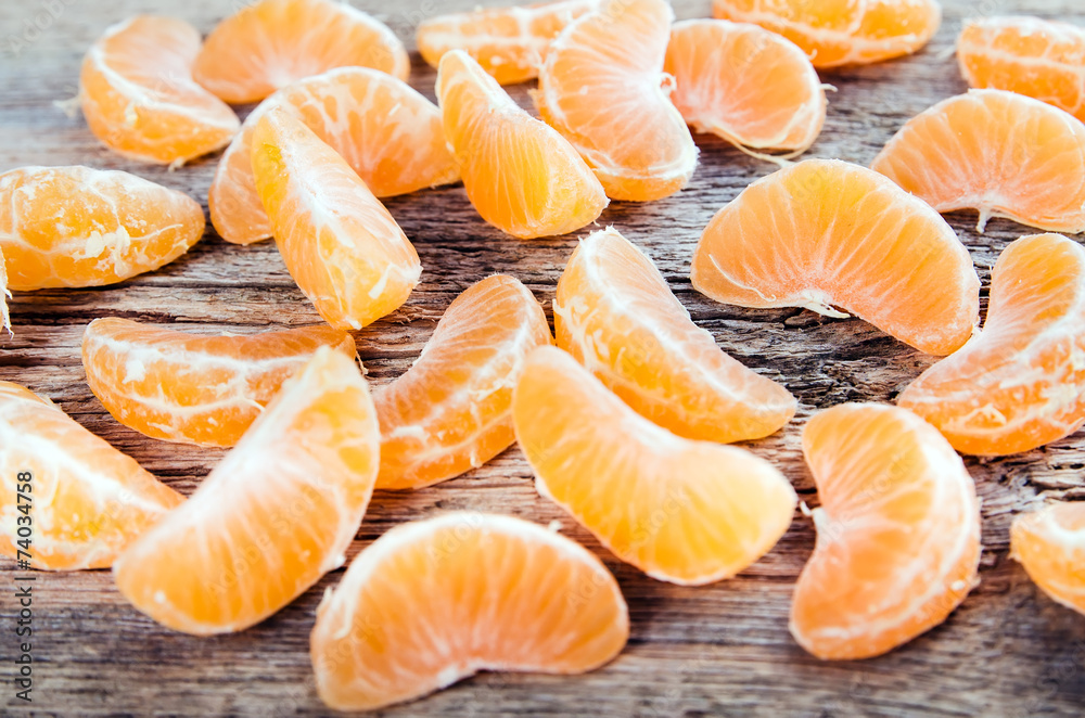 Ripe tasty tangerines on wooden background