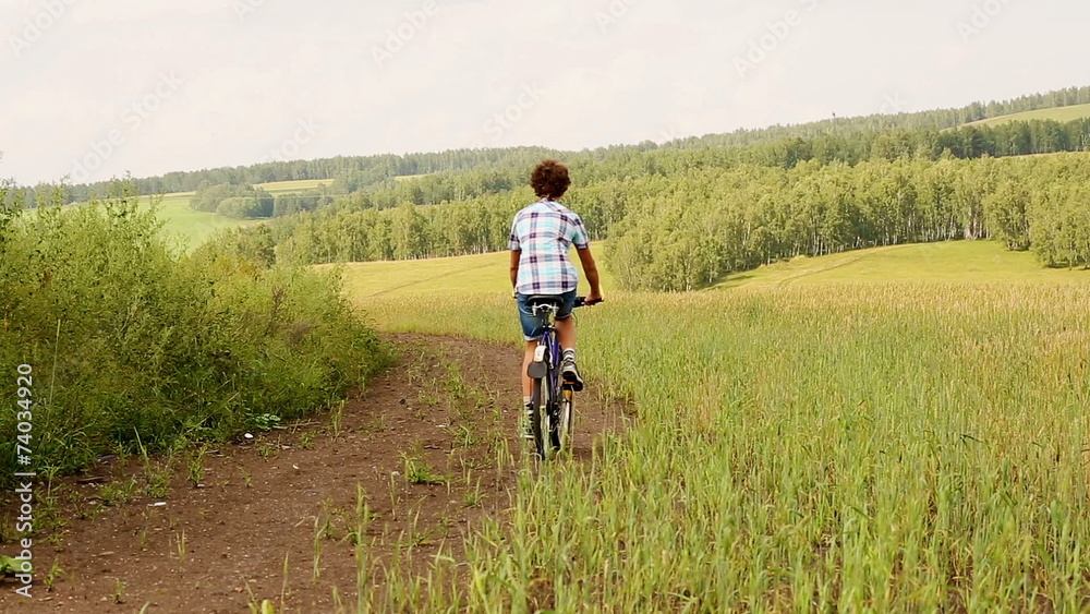 Young man with bicycle in a wheat field Young man with bicycle in a wheat field
