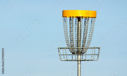 Frisbee golf basket against blue sky