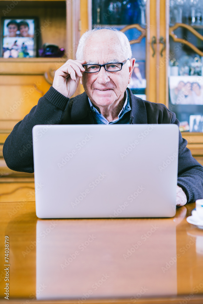 Senior working with Laptop at home Senior working with Laptop at home