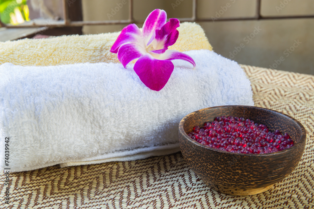 Spa and wellness setting with flowers and towel
