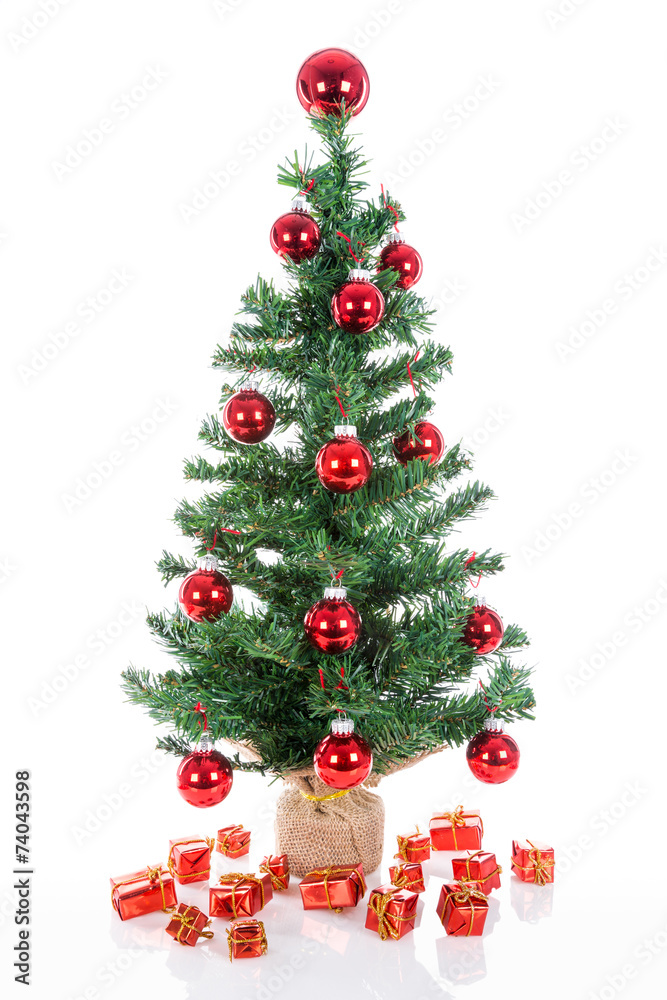 Christmas tree with red balls and gifts isolated at white