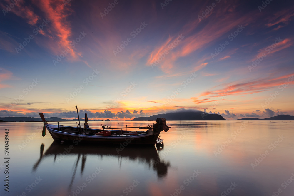 Silhouettes of longtail boat and sunrise in Phuket, Thailand Silhouettes of longtail boat and sunrise in Phuket, Thailand