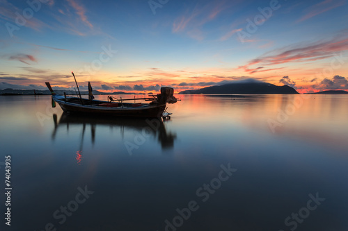 Silhouettes of longtail boat and sunrise in Phuket  Thailand