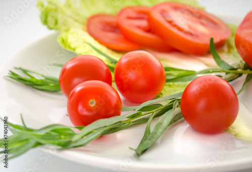 Fresh tomatoes, tarragon, onions on a plate © Stop war in Ukraine!