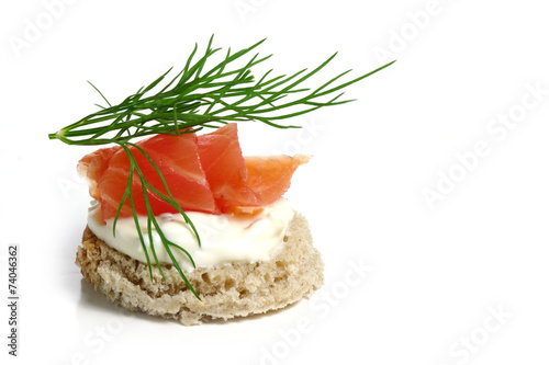 canape wiht salmon and  dill garnish,  isolated on white photo