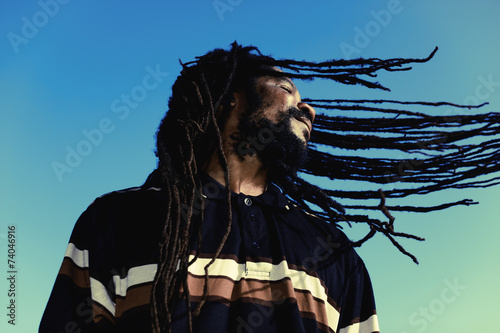 Happy man with “windy” dreadlocks. Caribbeans. photo
