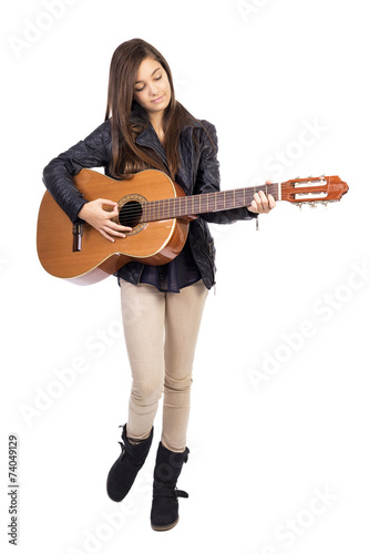 Beautiful teenager playing guitar