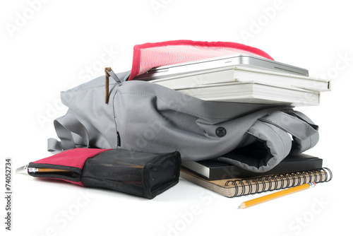 Backpack full of school supplies. on white background.