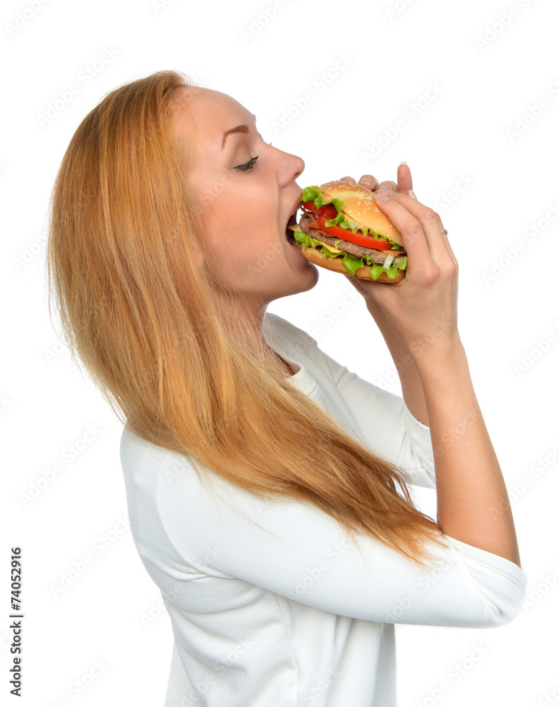 Fast food concept. Woman eating tasty unhealthy burger sandwich Fast food concept. Woman eating tasty unhealthy burger sandwich