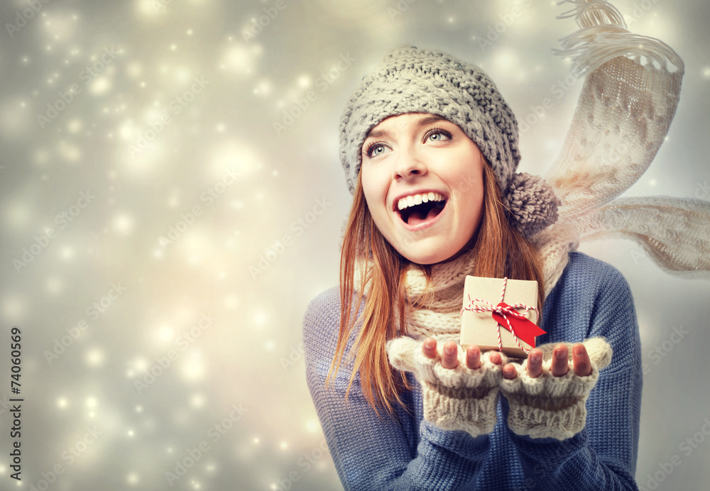 Happy young woman holding a small present box Happy young woman holding a small present box
