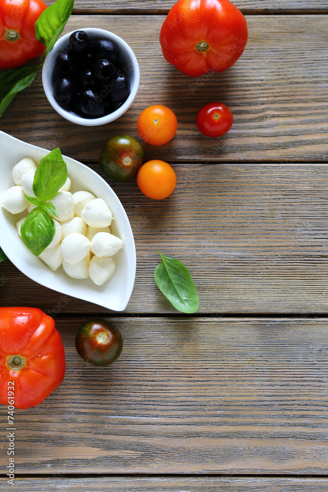 Mozzarella cheese and green basil in a bowl Mozzarella cheese and green basil in a bowl