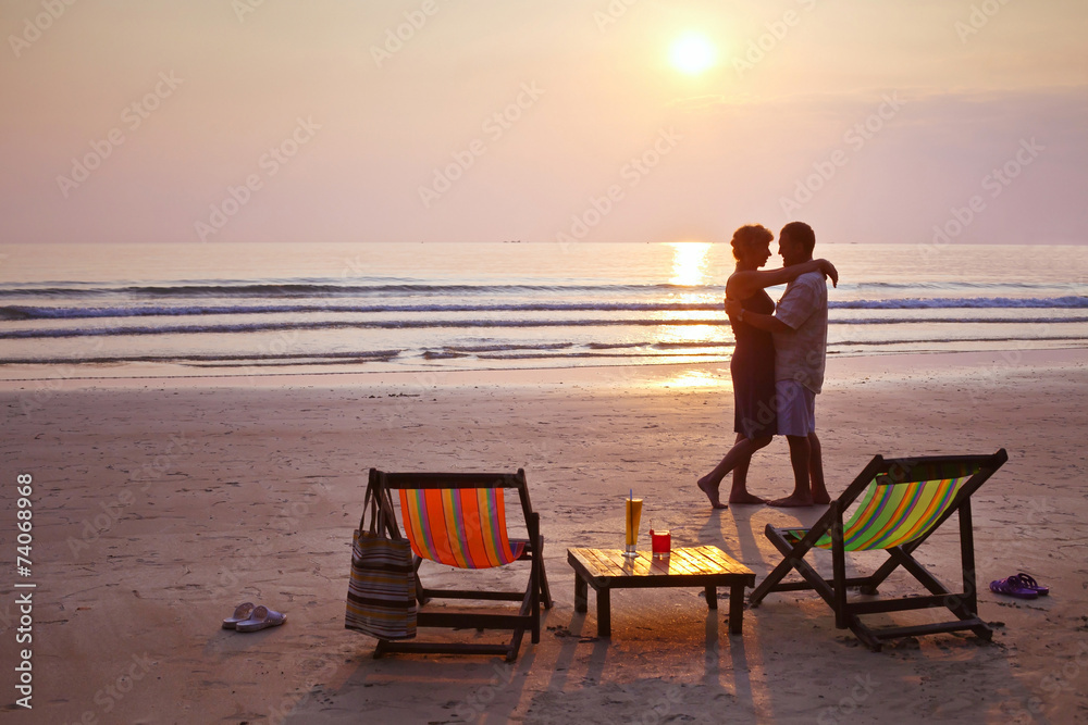 happy couple on the beach at sunset