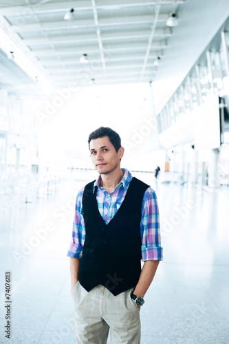 Man with serious look on a background of departure board at airp
