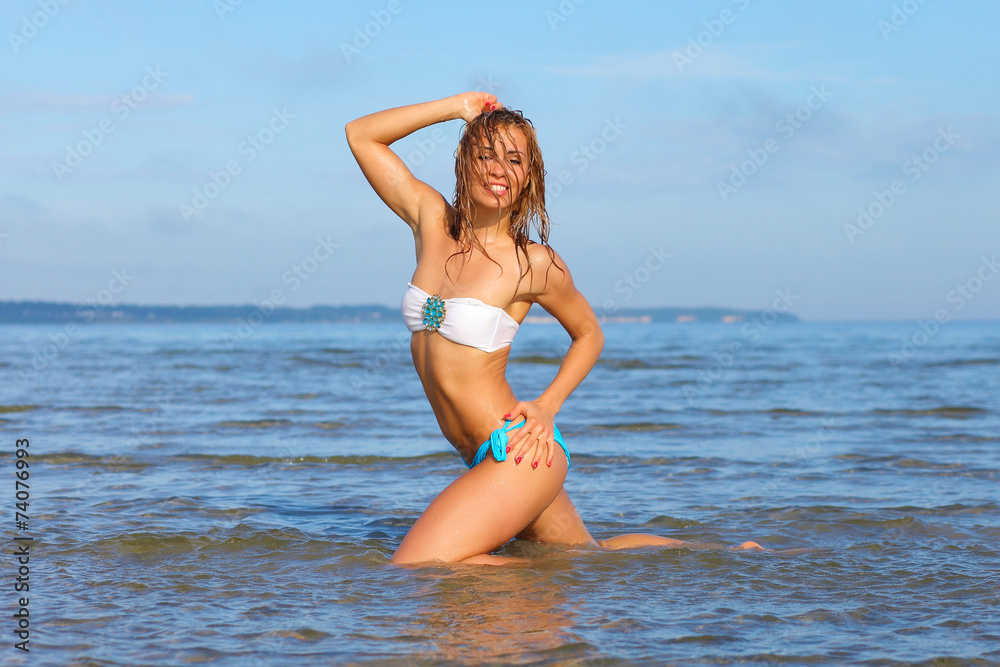 Fototapeta premium young sexy girl in a swimsuit at the sea