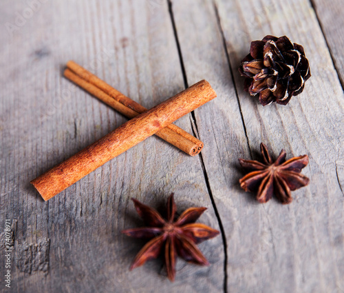 Close-up of anise star and cinnamon stick grouped on wooden back