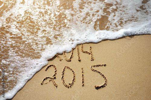 Happy Near Year concept 2015 replace 2014 on sea beach
