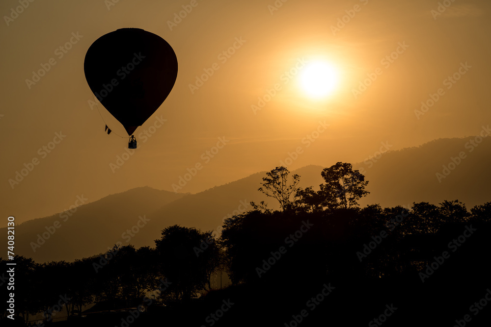The silhouette of hot air balloon flying up in the sky during sunset view. The silhouette of hot air balloon flying up in the sky during sunset view.