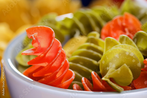 Variety of uncooked italian pasta on wooden table photo