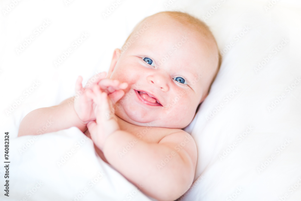 Peaceful newborn baby lying on a bed Peaceful newborn baby lying on a bed