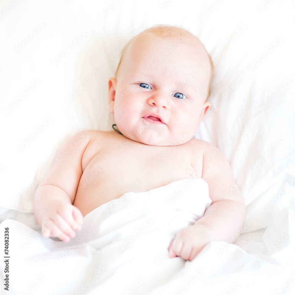 Peaceful newborn baby lying on a bed Peaceful newborn baby lying on a bed