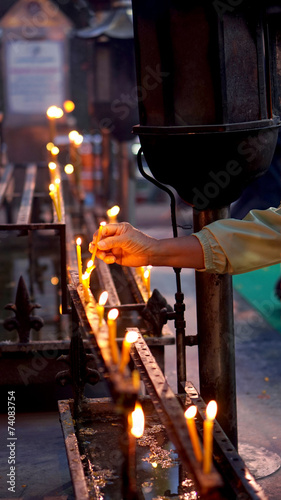 hand lit candle photo