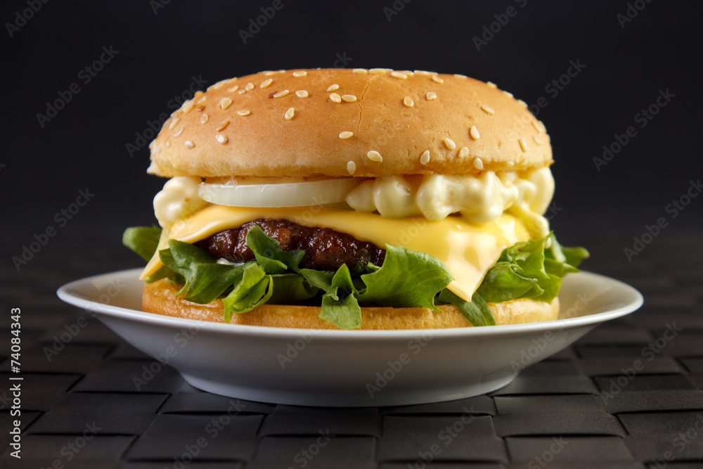 Cheeseburger with mayonnaise on dish Cheeseburger with mayonnaise on dish
