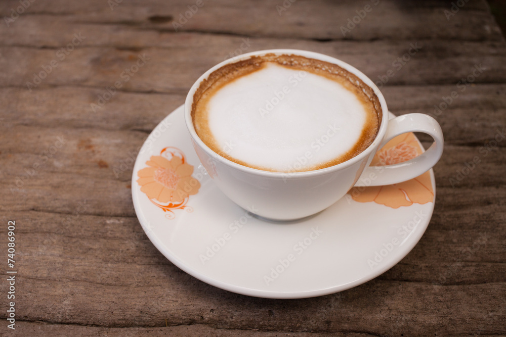 Cup of hot cappuccino coffee on wooden table. Cup of hot cappuccino coffee on wooden table.