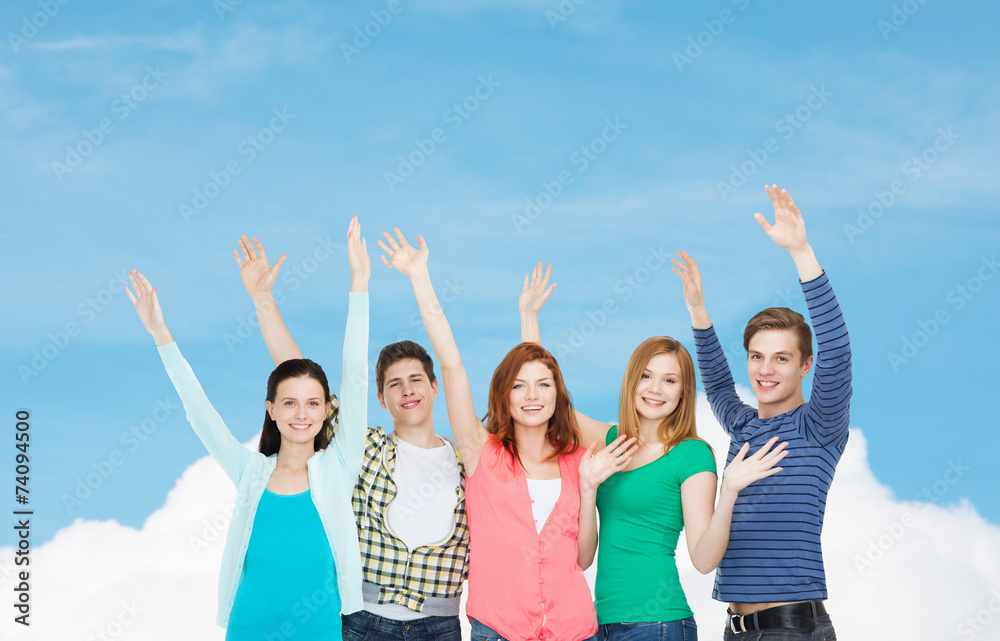 group of smiling students waving hands group of smiling students waving hands