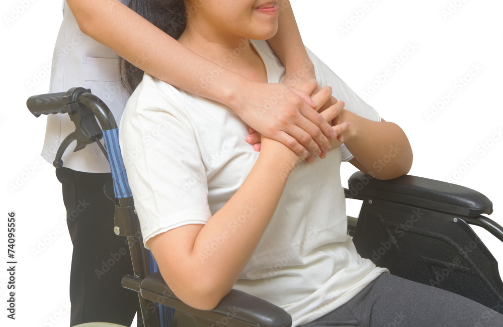 Caring doctor holding patient's hands in wheelchair