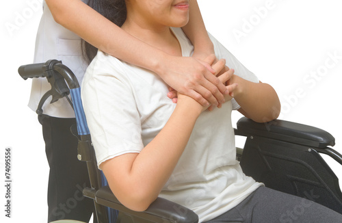 Caring doctor holding patient's hands in wheelchair