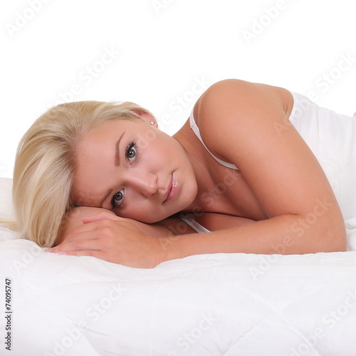 Young woman in bed isolated