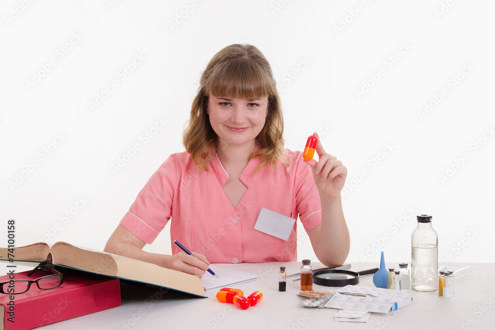 Pharmacist writing in a notebook composition pills Pharmacist writing in a notebook composition pills