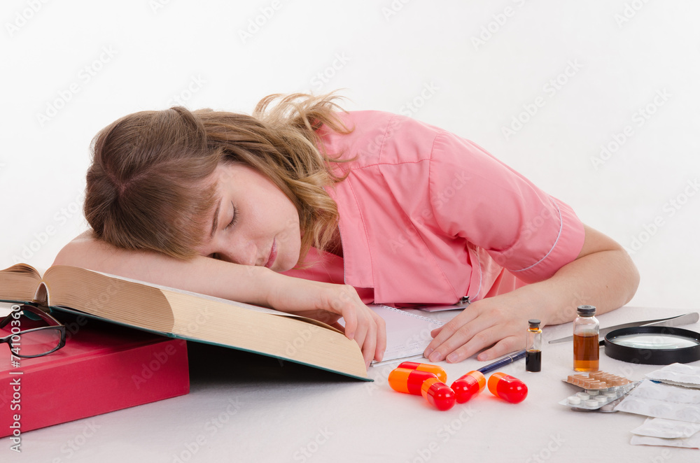 Tired pharmacist sleeping on the reference Tired pharmacist sleeping on the reference