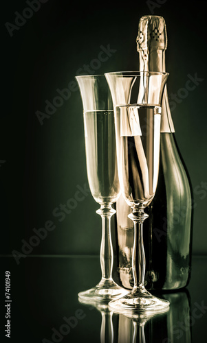 bottle of champagne with two full glasses