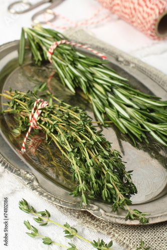 Fresh aromatic herbs rosemary and thyme on metal plate