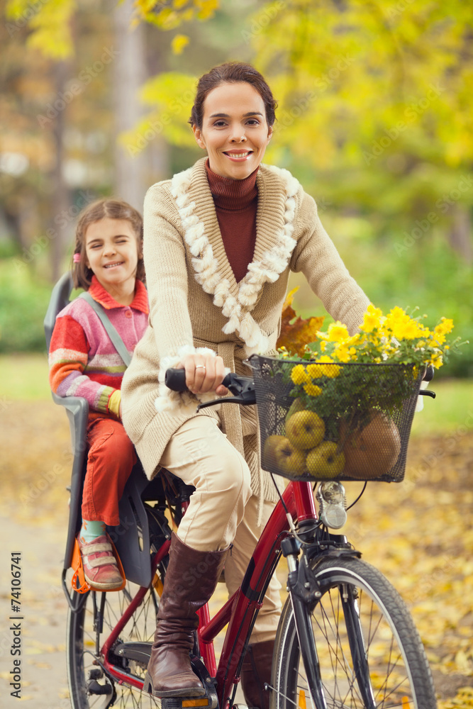Young mother riding a bilcycle Young mother riding a bilcycle