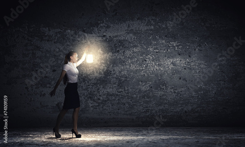 Businesswoman with lantern