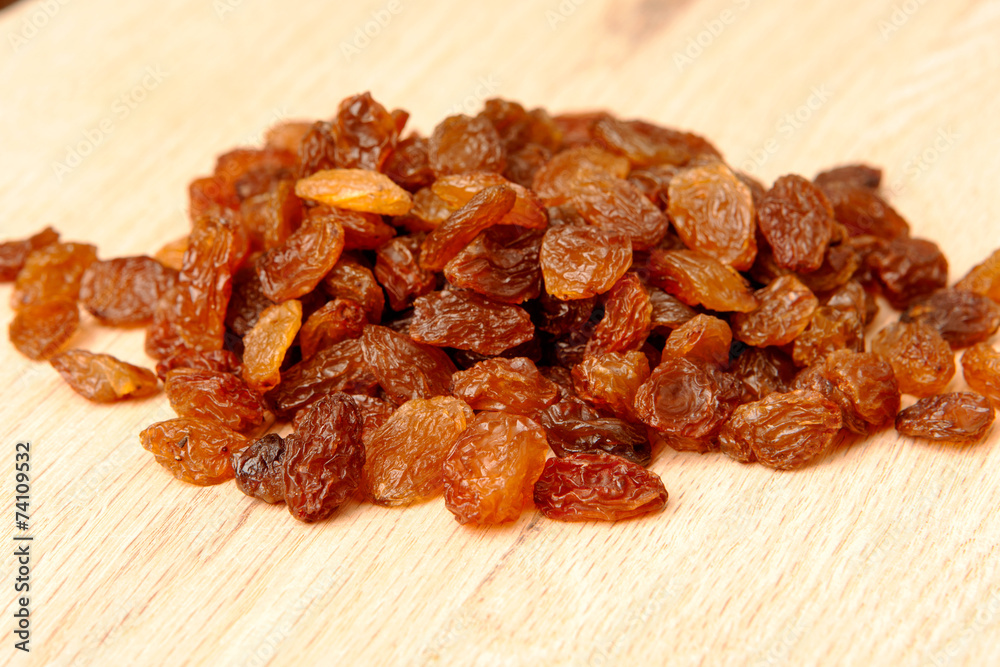 Raisins on wood plank, background
