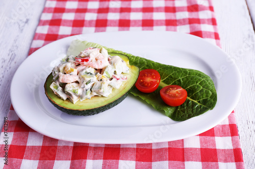 Tasty salad in avocado on plate table close-up