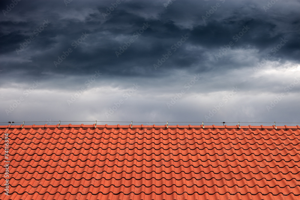 Dark rain clouds above the orange roof.